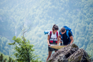 Hikers,using,map,to,navigate,outdoor