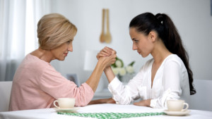 Mother,and,daughter In Law,looking,on,each,other,during,arm,wrestling